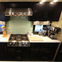 Custom RV kitchen from New Horizons set up with countertop appliances